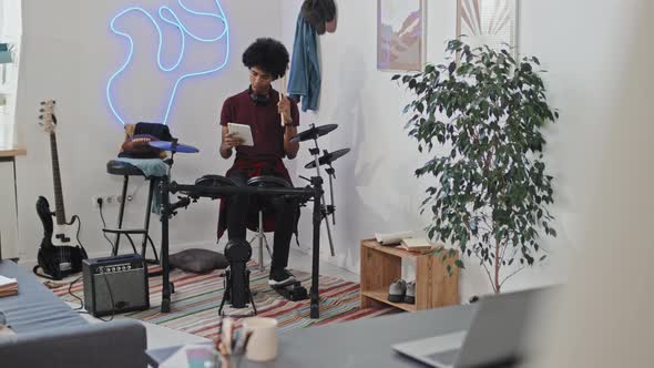 Young Man Playing Electronic Drums alt