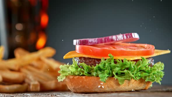 Super Slow Motion Shot of Falling and Stacking Parts of Cheeseburger at 1000Fps alt