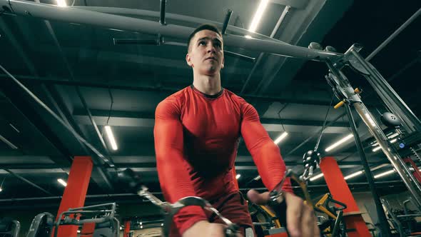 Male Athlete Is Stretching His Arms During Crossfit Practice alt