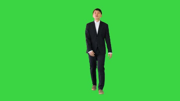 Asian Man in Suit Walking and Speaking on a Green Screen Chroma Key alt