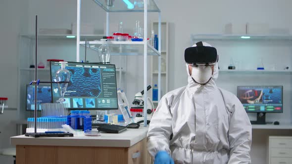Scientist Researcher in Protection Suit Using VR alt