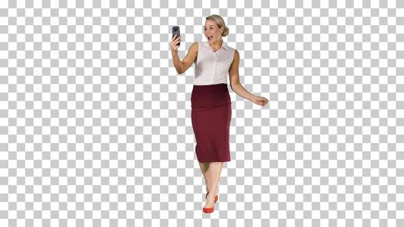 Walking woman making a video call using smart phone, Alpha Channel alt
