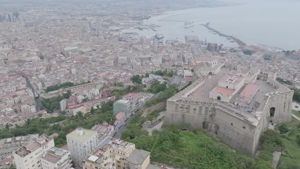 Wide aerial video of Castel Sant'Elmo panning up to revealing Mount Vesuvius and the harbor in Naple alt