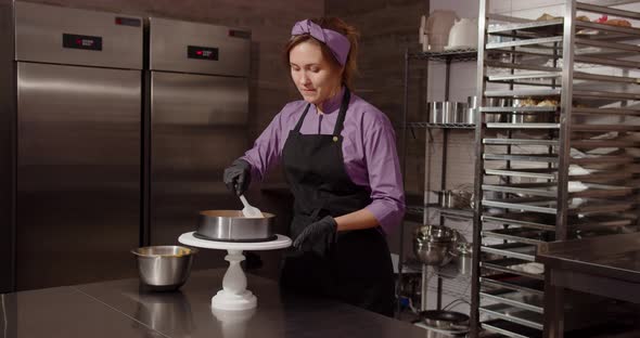 A Professional Confectioner Pours Sweet Caramel Into The Confectionery And Decorates The Cake.