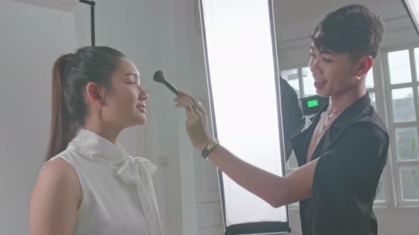 Backstage Of The Photo Shoot: Make-Up Artist Applies Makeup On Beautiful Asian Model alt