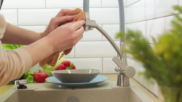 Young Woman Hands in Washing the Kitchen Sink and Faucet