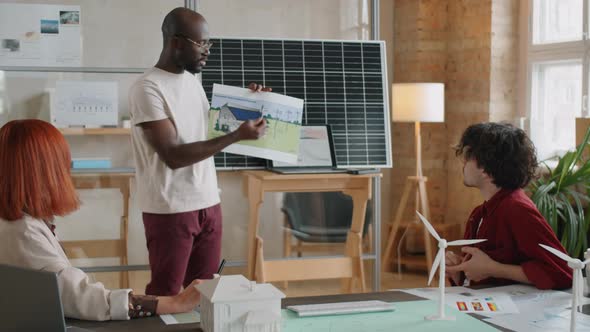 Afro-American Engineer Presenting Alternative Energy Project in Office alt
