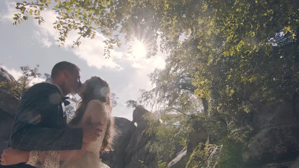 A Real Kiss of Two Young People in Love on the Street in the Park. Sincere Kiss of Young People on a alt