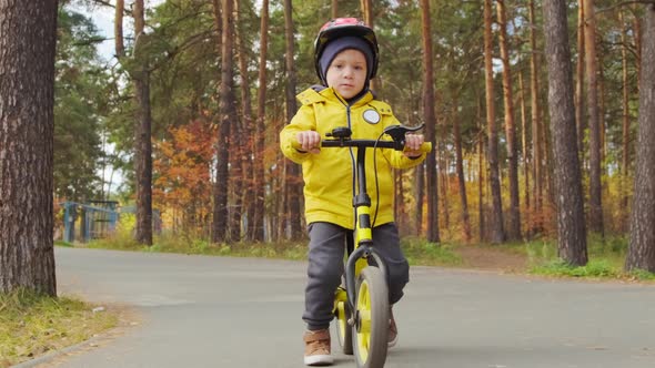 5-Year-Old Boy Riding Balance Bike alt