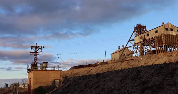 As the sunset over the Junction Mine Broken hill NSW Australia in the golden hour after a storm has alt