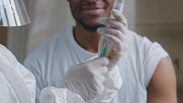 Closeup Nurse Doctor in Medical Protective Uniform Latex Gloves Holding Bottle Vaccine Dose of alt