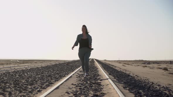Young Woman Walks at Abandoned Railway Near Garub Railroad Station