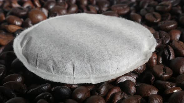 Coffee pods with roasted  beans 4K tilting footage alt