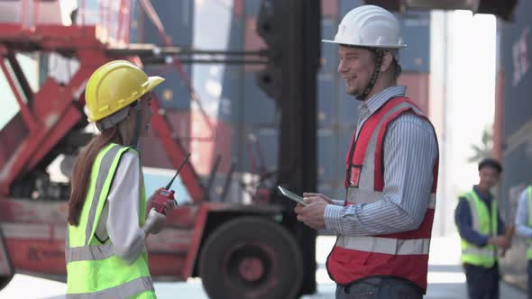 Dock worker team meeting in shipyard, Engineer and foreman in hardhat