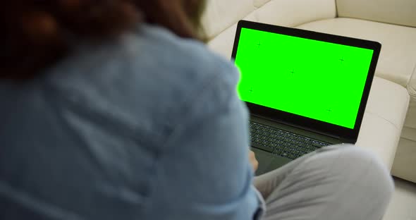 Woman with Laptop Chromakey on Sofa