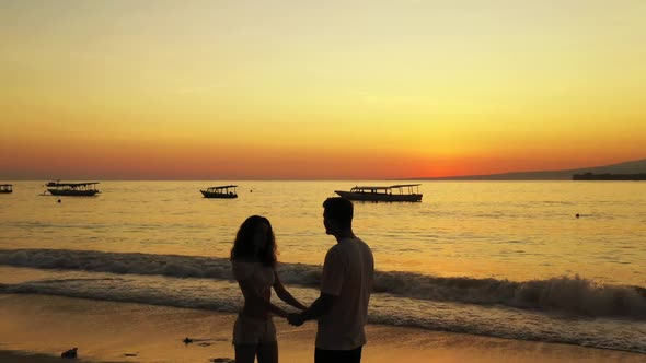 Man and woman relax on relaxing bay beach break by turquoise sea and white sand background of Gili A alt