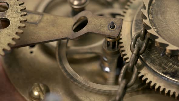 Close-up Spinning Gears, Very Similar To a Clock Mechanism or a Working Device in the Old Style. alt