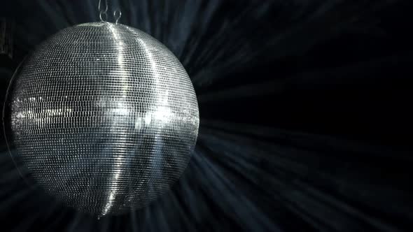 A Mirrored Disco Ball is Spinning at a Party