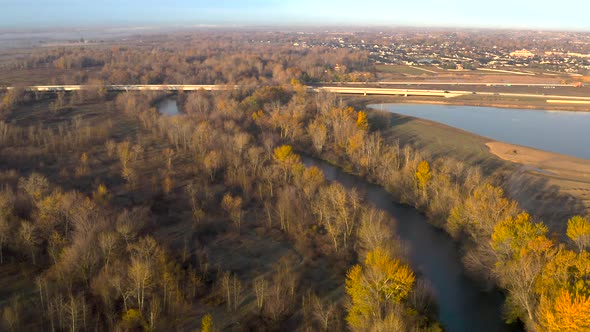 High up aerial shot of Boise River flowing through Idaho's beautiful landscape. alt