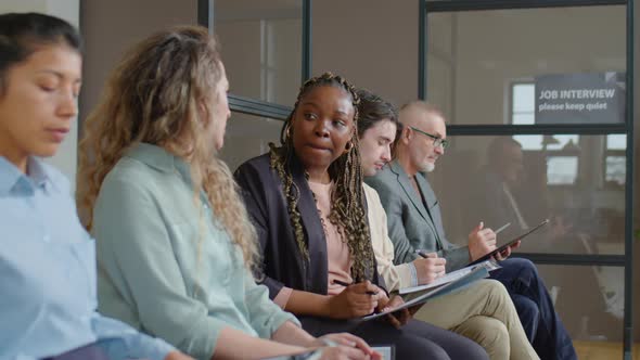 Women Sitting in Line and Chatting before Job Interview alt