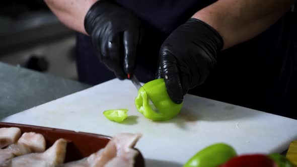 Woman Chopping Vegetable on Board