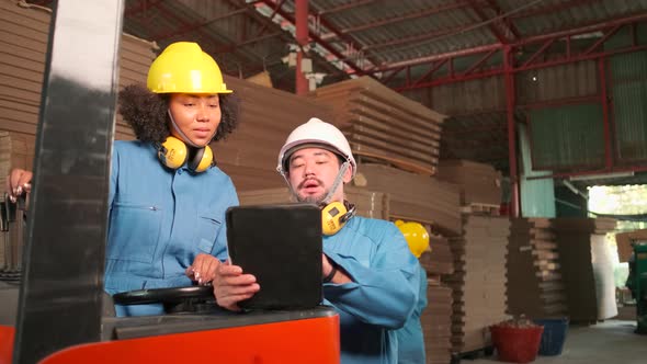 Industrial engineer workers team inspect cardboard storage at factory warehouse. alt