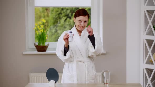 Confident Happy Mature Woman Advertising Vitamin B Complex Gesturing Thumb Up Smiling Looking at alt