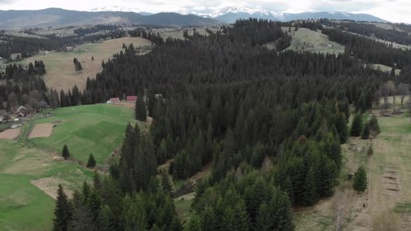 Snowy mountain peaks and cloudy sky. Carpathian mountains from bird's eye view. alt