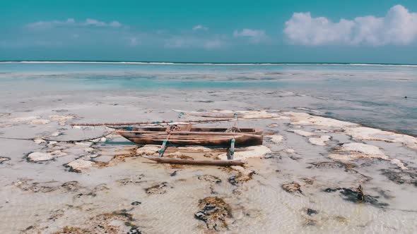 Ocean at Low Tide Aerial View Zanzibar Boat Stuck in Sand on the Shallows alt