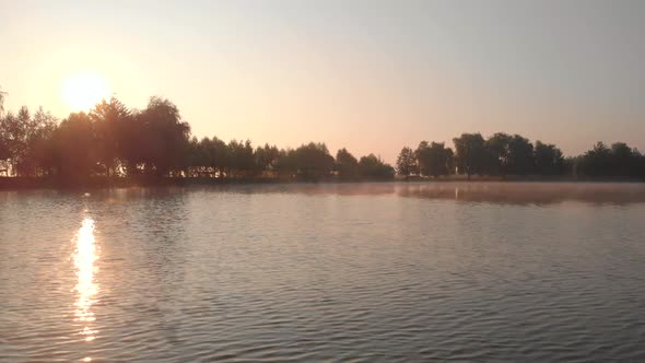 Sunrise on the Lake Reflection of Sun in Water alt