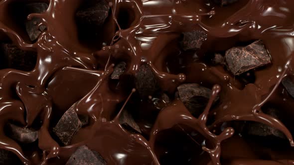 Super Slow Motion Shot of Raw Chocolate Chunks Falling Into Melted Chocolate at 1000 Fps alt