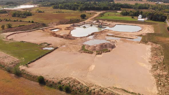 Aerial view of a sand, gravel mine quarry full with water