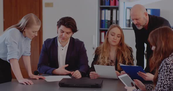 Colleagues Discussing Strategy in Meeting at Office alt