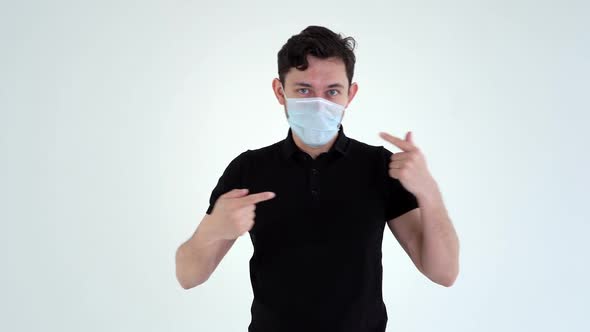 Happy Young Man Wearing Protective Mask Is Dancing on Isolated White Background. alt