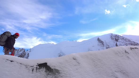 Climber Goes On A Snowy Ridge alt