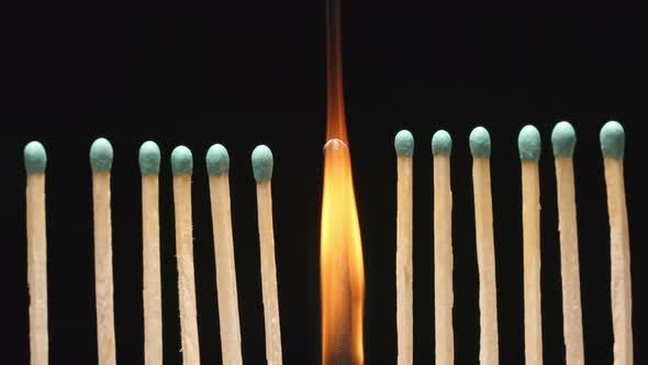 Burning of single matchstick between row of new matchsticks