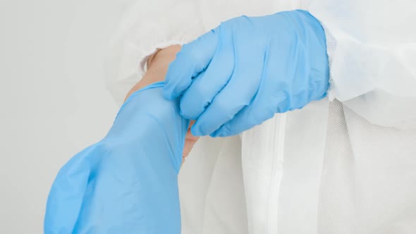 CLoseup of Female Docto Putting on Protective Rubber Gloves in Hospital alt