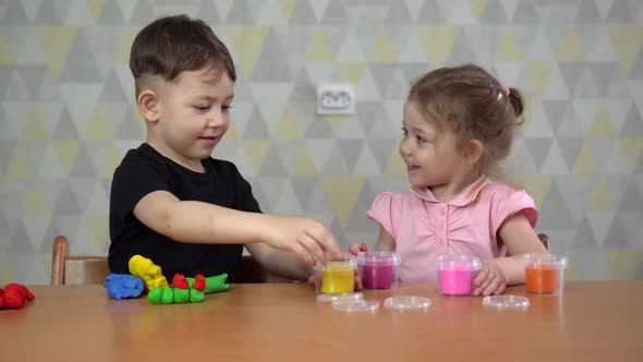 Kids Boy and Girl Play in Kindergarten with Interest. Children Sculpt From Plasticine in Day Care