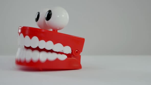 Vintage wind-up teeth nearly chatter off the screen.