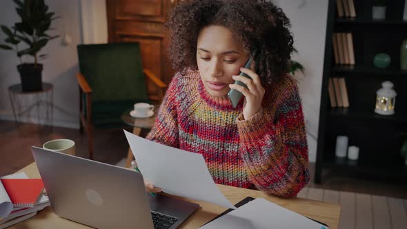 Young African American Woman Freelancer Discussing Order Details with Client Via Cellphone Working alt