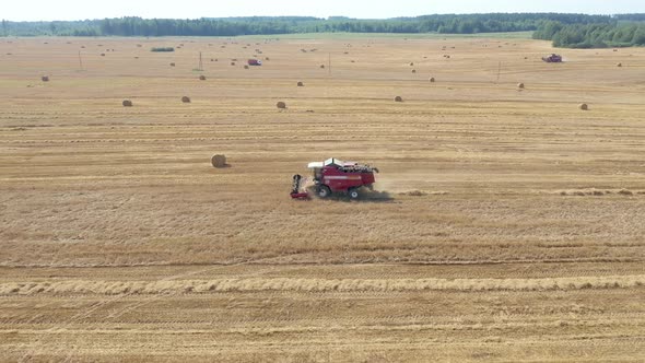 Farmer On Combine Harvest Ripe Wheat Grain In Agricultural Field Aerial View alt