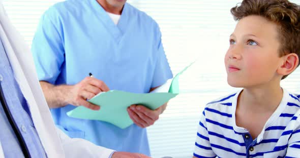 Male doctor checking blood pressure of patient alt