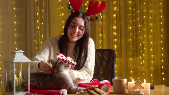 Happy Woman Playing Cat Alone Home During Christmas