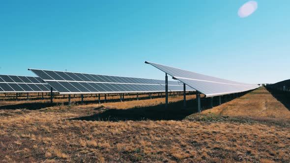 Open Field with Rows of Solar Constructions. Energy Efficiency, Energy Saving Concept. alt