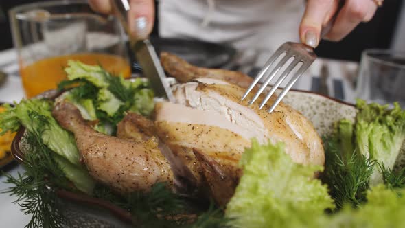Closeup Woman Cuts with a Knife Oven Baked Chicken alt