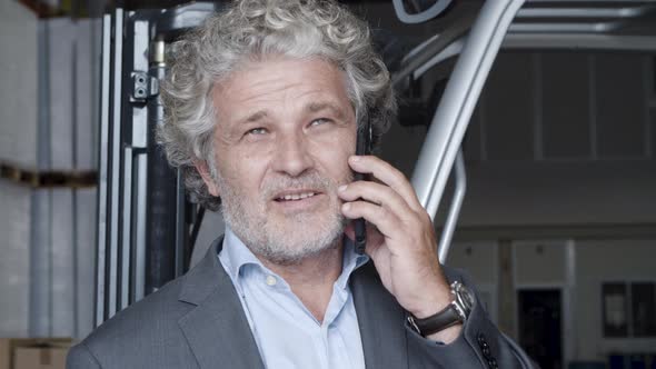Closeup of Pensive Businessman Talking on Phone alt