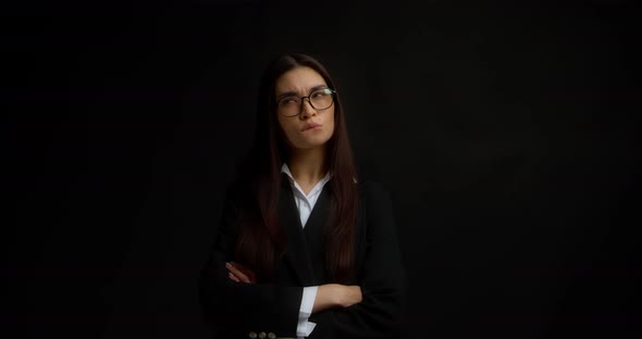 Brunette in Glasses and Office Clothes Remembers Something and Bites Her Lip
