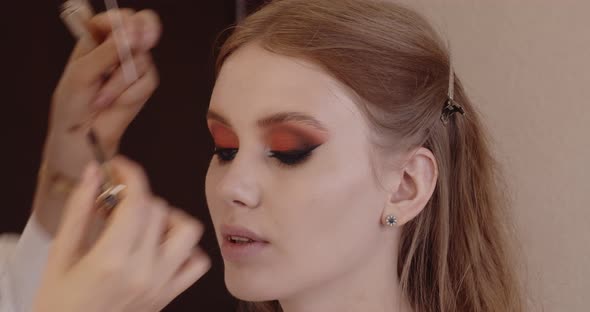 Beautiful girl has her makeup done in a beauty salon.