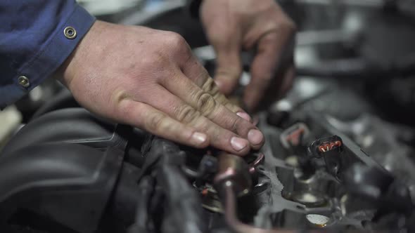 Male Young Auto Specialist Taking and Repairing Parts in the Gearbox of the Car in Planning Car alt