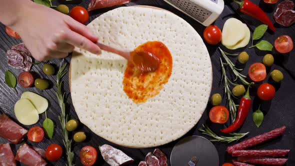 Top View of Making a Pizza with Ingredients Appearing on the Baking Plate alt